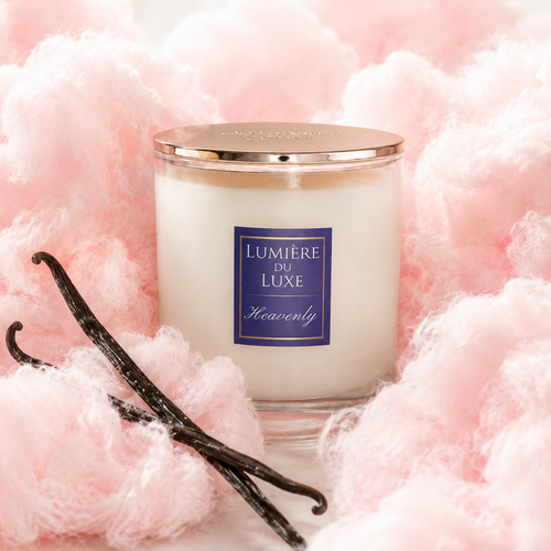 A heavenly candle with gold lid surrounded by cotton candy and vanilla.
